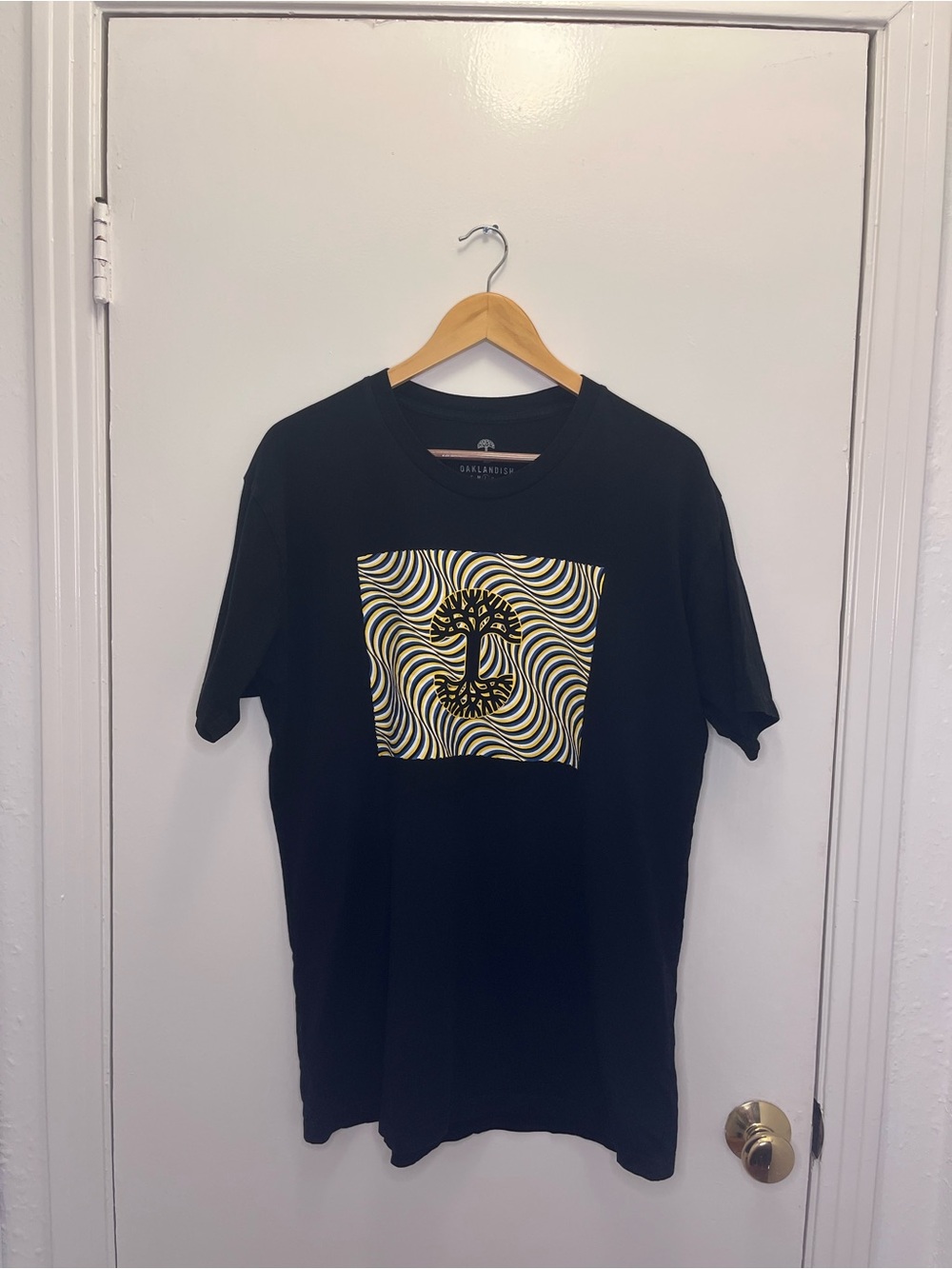 Oaklandish Men's Black Graphic Tee with Yellow Wave Print